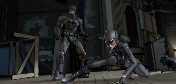 Batman and Catwoman in a dark room.