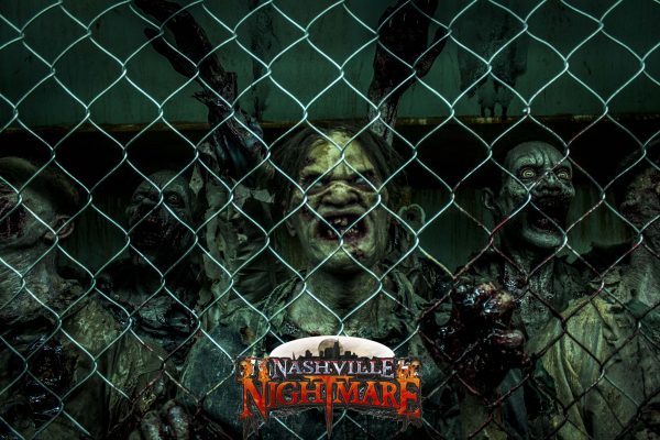 Zombies trapped behind a chain link fence.