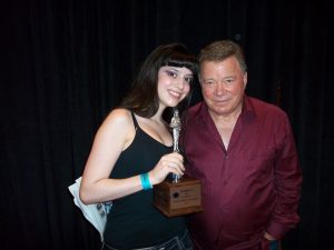 Deena Roth, RunnerUp at the 1st Annual Dragon Con Miss Star Trek Universe Pageant in 2010, here with William "Captain James T. Kirk" Shatner and her trophy which he signed at a subsequent 2011 Star Trek Convention in Nashville.