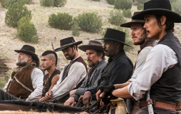 Seven men in cowboy hats on horseback.