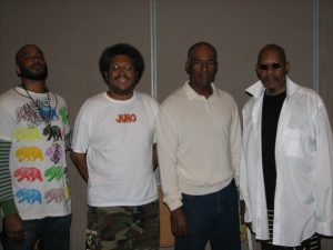 From left: Cirroc Lofton, Cass Teague, Michael Dorn and Avery Brooks. Brooks played Ben Sisko, Dorn played Worf, and Lofton played Jake Sisko on Star Trek Deep Space Nine. Photo taken at Dragon Con in 2008.