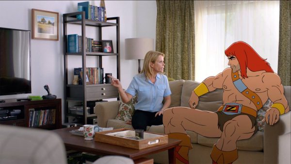 Woman arguing with He-Man on couch.