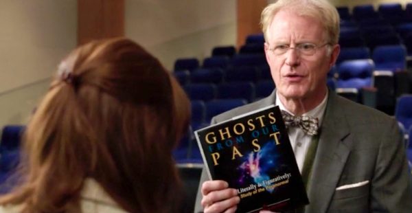 Man holds book titled "Ghosts From Our Past"