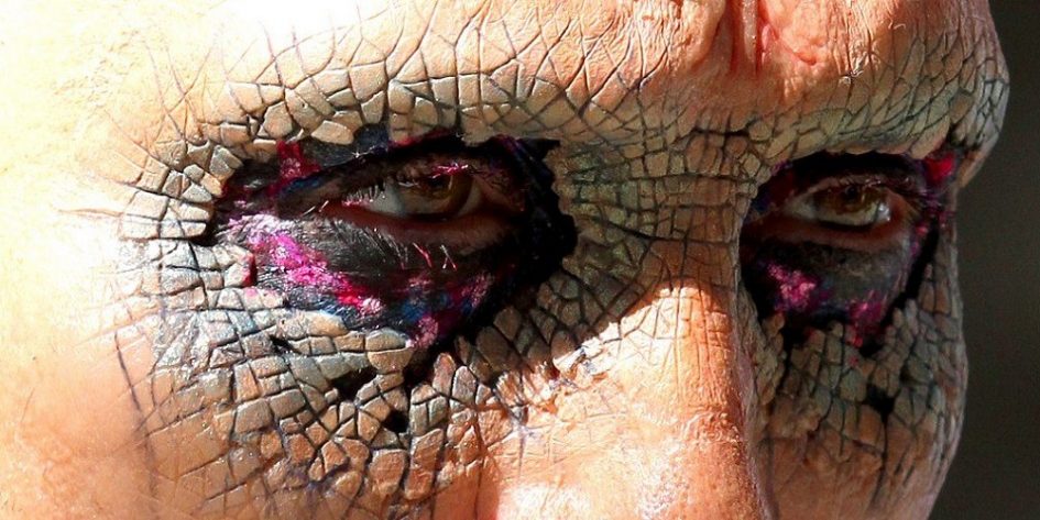 Close-up of a man's eye with cracked skin makeup.