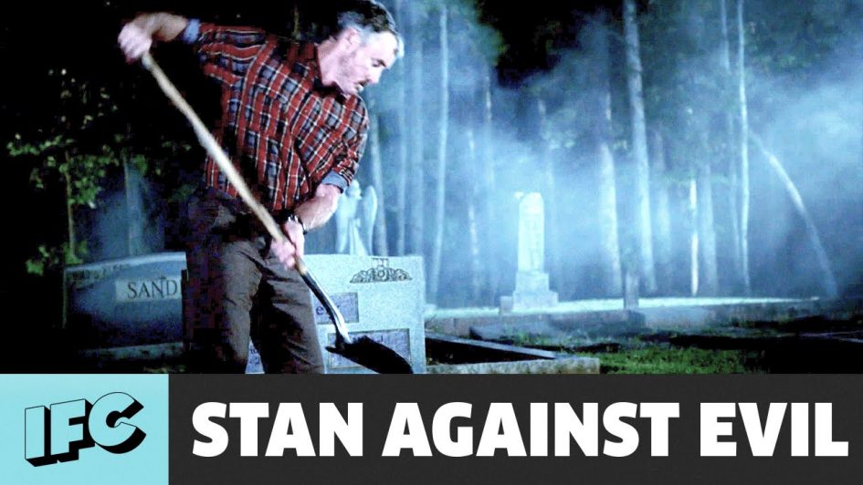 Man digging a grave in a cemetery.