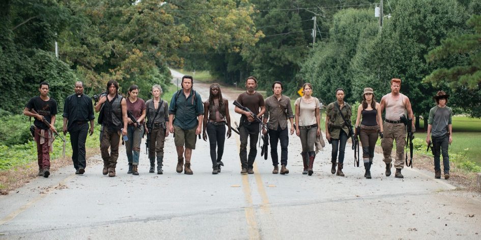 The Walking Dead cast walking down a road.