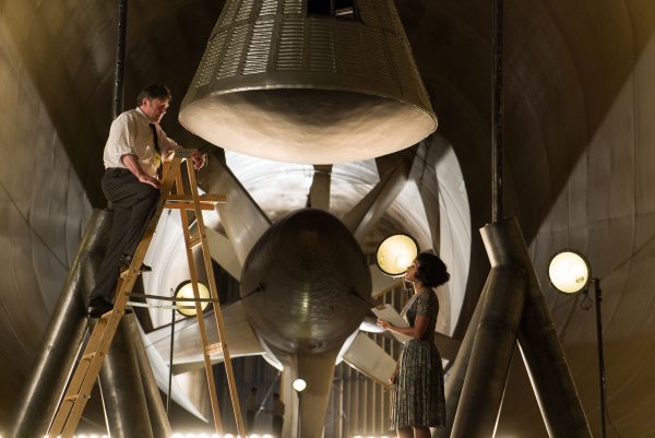 Two people in a large space capsule.