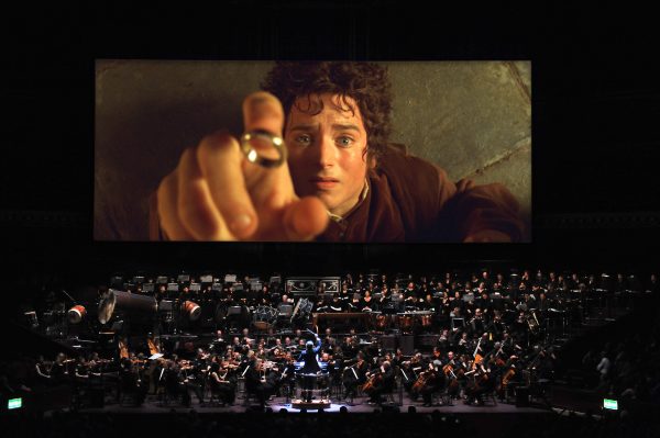 Frodo holding the ring, orchestra performing.