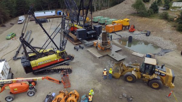 Construction site with cranes and excavators.