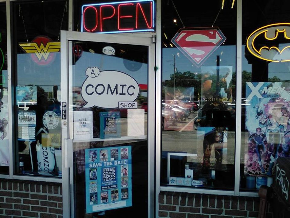 Comic shop storefront with superhero signs.