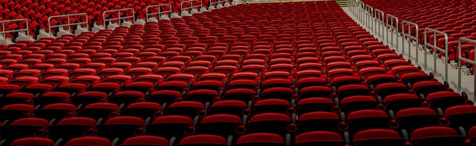 Rows of red stadium seats.