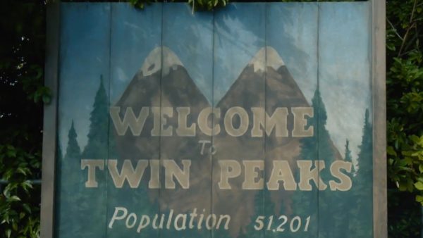 Welcome to Twin Peaks sign with mountains.