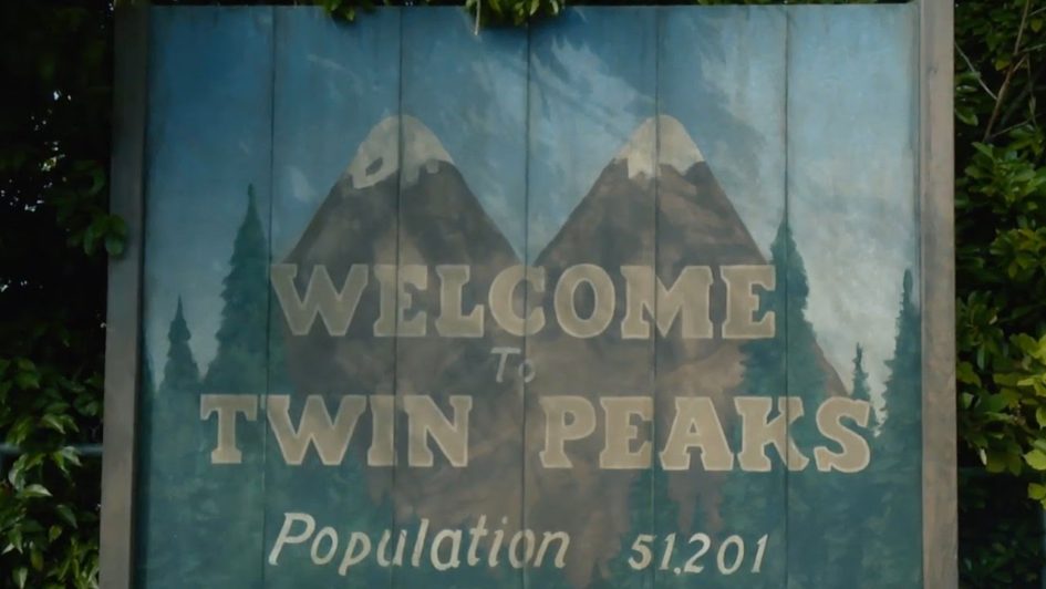 Welcome to Twin Peaks sign with mountains.