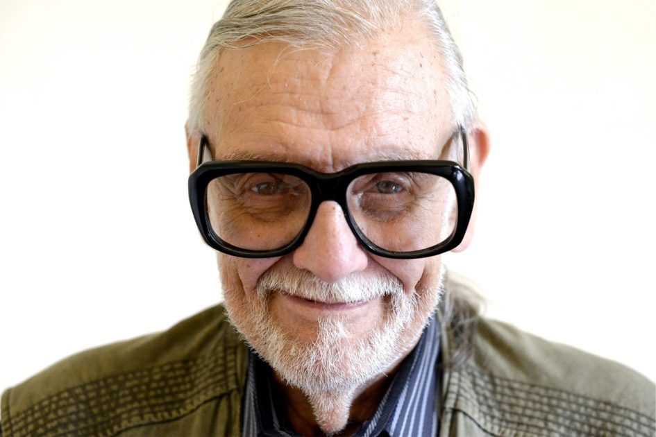 Smiling elderly man wearing glasses.