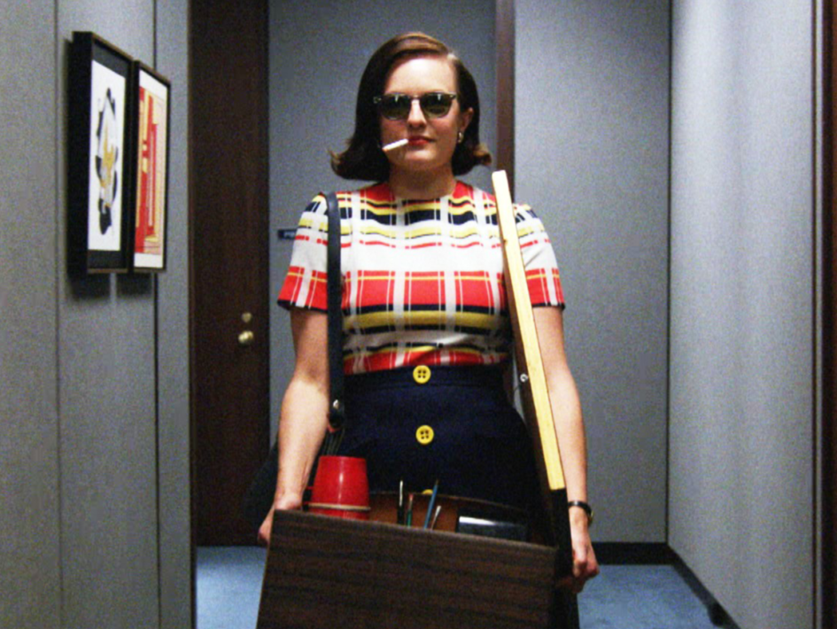 Woman in a plaid dress leaving an office.