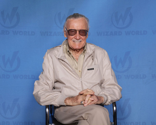 Stan Lee, smiling, wearing glasses.