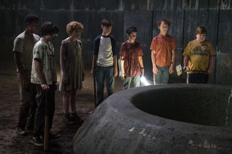 Group of kids standing near a well.