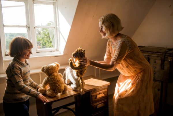 Woman and boy playing with stuffed animals.