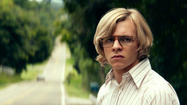 Young man with glasses on a country road.