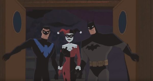 Batman, Robin, and Harley Quinn stand together.