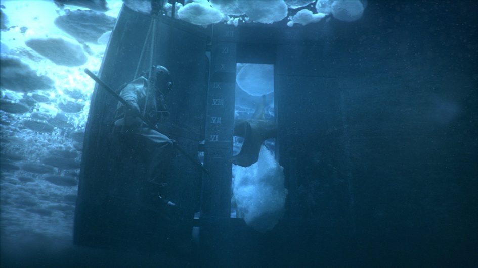 A man in a boat underwater with ice.