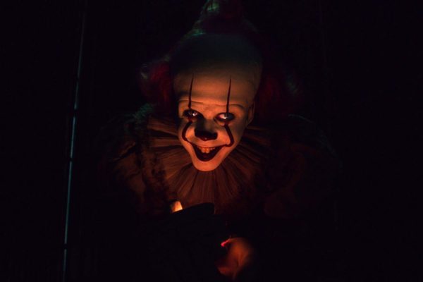 Pennywise the Dancing Clown with a candle light under his face