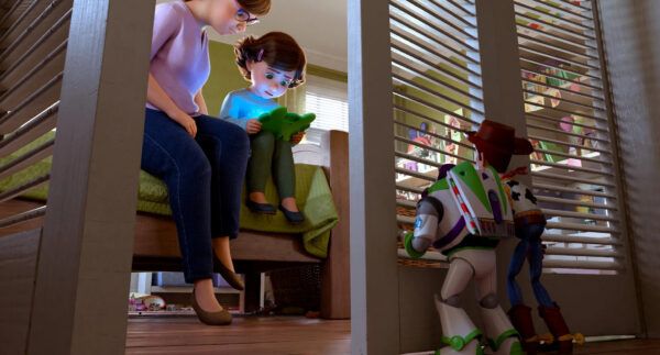 Woody and Buzz watch as Bonnie and her mom look at her new Lilypad tablet in Toy Story 5