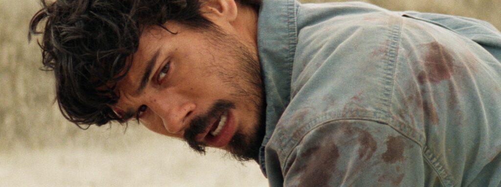 Close view of Ben leaning forward in a dusty shirt in Split Rock.